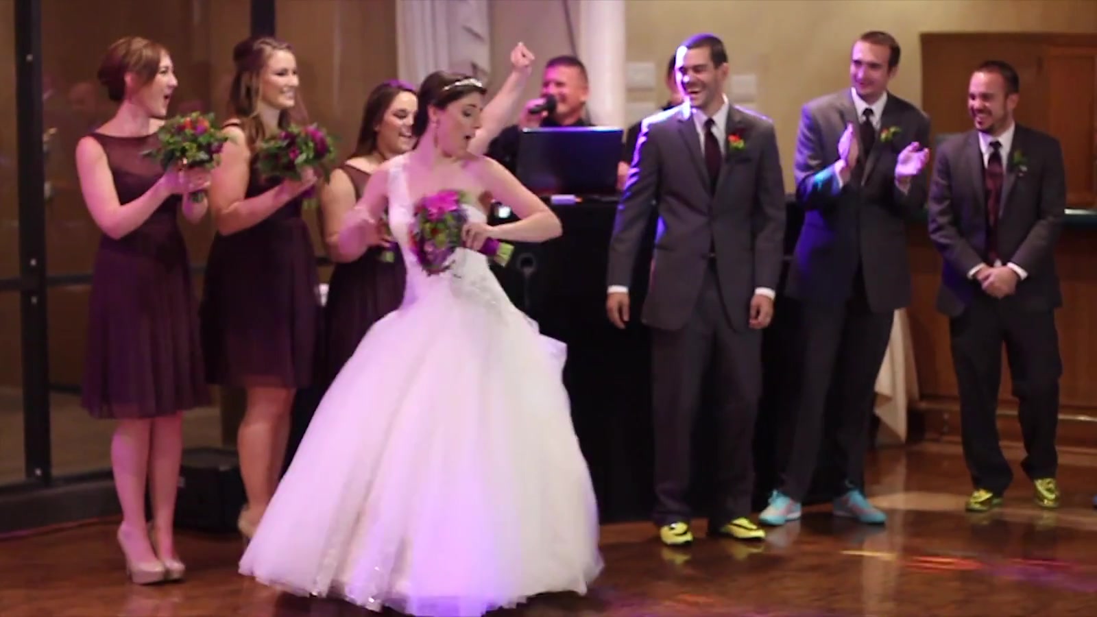 The couple cheering as the room turns over to dancing