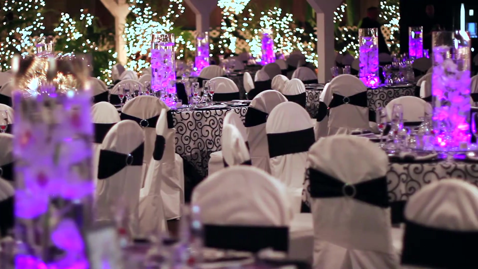 Garden Room tables set with glowing purple orchid centerpieces