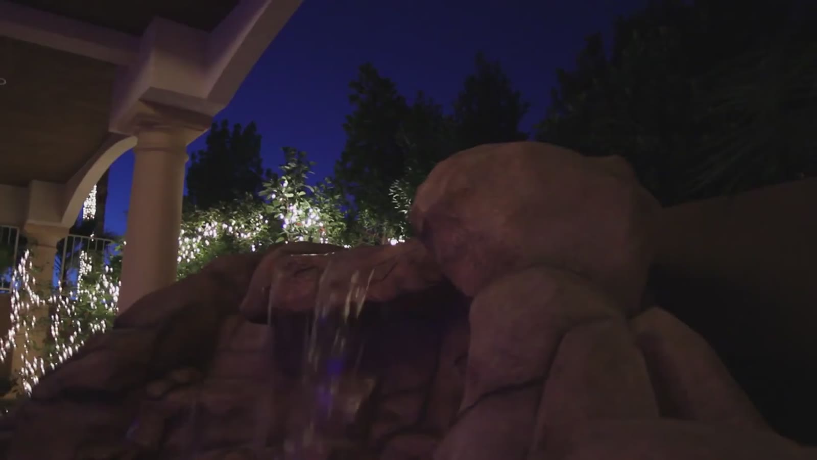 The rock waterfall lit at night