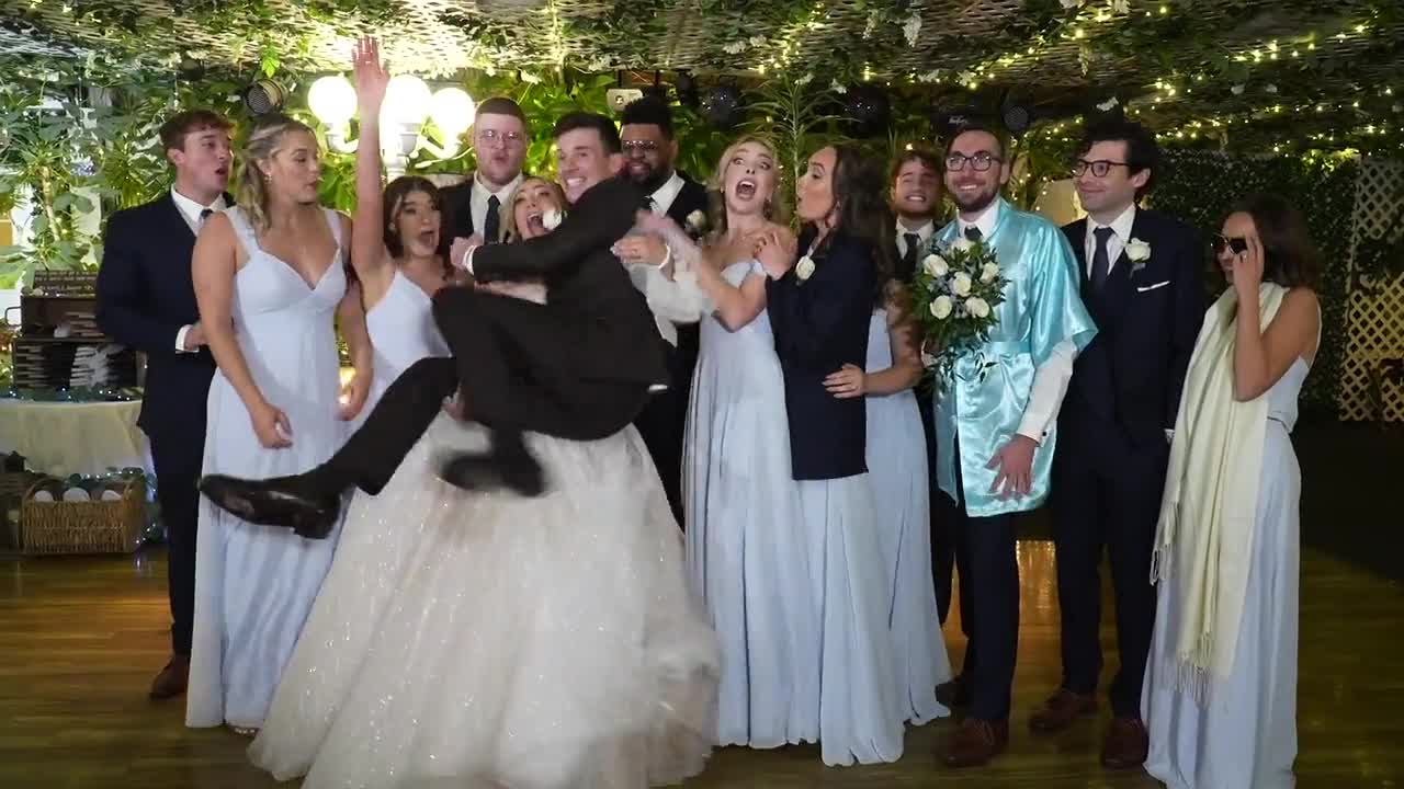 The wedding party celebrating on the dance floor under the garden lights